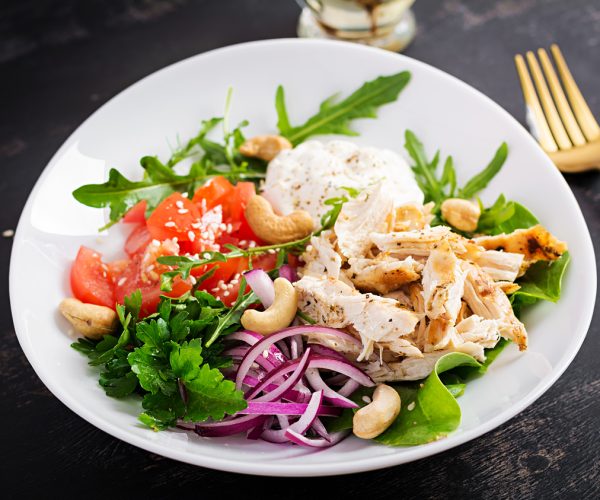 Healthy vegetable summer salad, fresh vegetables and chicken breast with yogurt dressing. Keto, ketogenic diet.